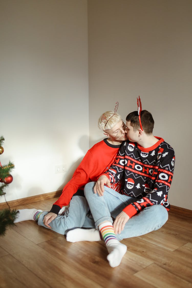 Men Sitting On The Floor While Kissing