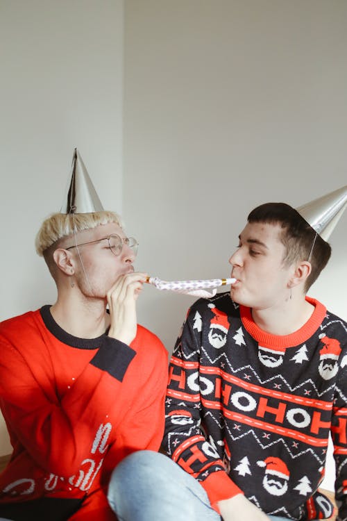 A Couple Wearing Christmas Sweaters