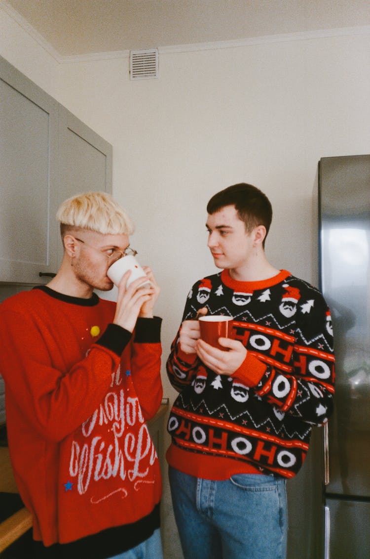 Two Men Standing While Drinking Coffee 