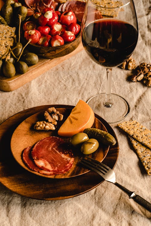 Free Wooden Plates Beside a Wine Glass Stock Photo
