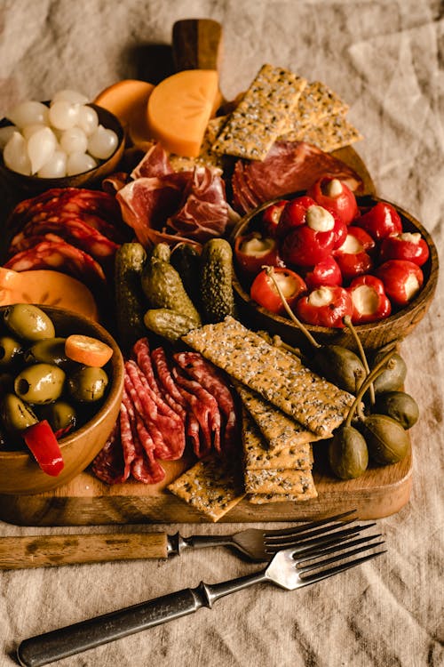 Pickles and Crackers on Brown Wooden Tray