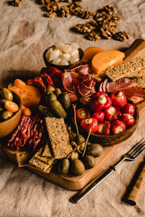 Sliced Fruits and Crackers on Brown Wooden Tray