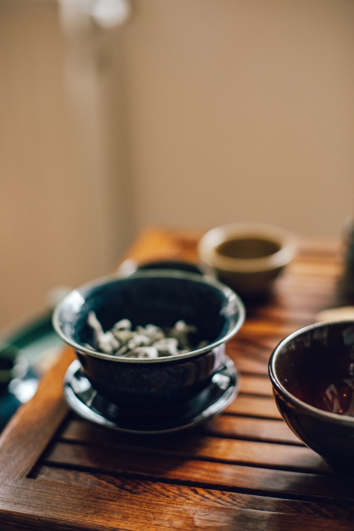 Loose leaf tea steeping in a gaiwan, lid tilted to pour