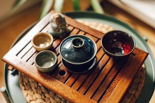 陶瓷茶具在木制托盘上，展示了带有泥土色调的日式设计