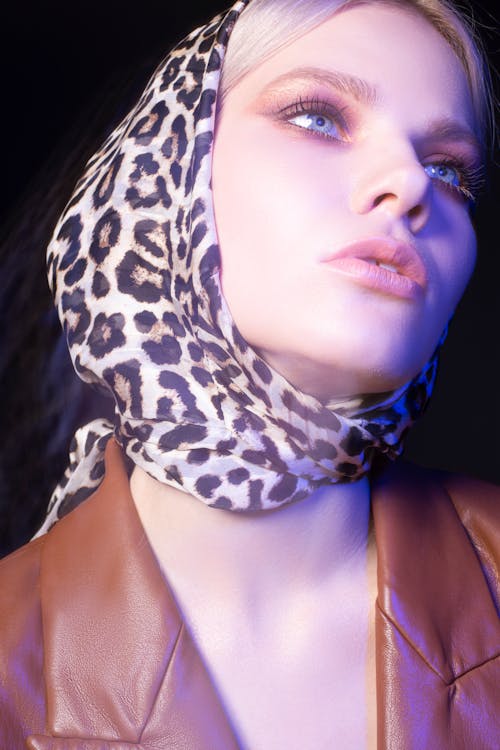 Content stylish woman in trendy headscarf looking up