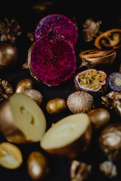 Free Sliced Dragon Fruit Surrounded by Gold Ornaments  Stock Photo