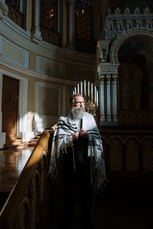 Free A Man in Black Suit Standing on the Altar while Looking Afar Stock Photo