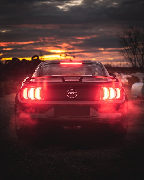 Free Contemporary expensive car with luminous red taillights Stock Photo