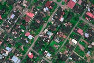 Settlement with various houses and roads on sunny day