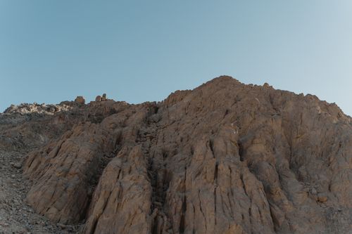 Free Low angle view of a rugged canyon rock formation against a clear blue sky, captured outdoors. Stock Photo