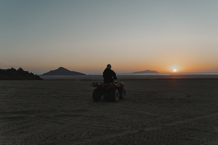 Person Riding A Quad Bike In The Desert 