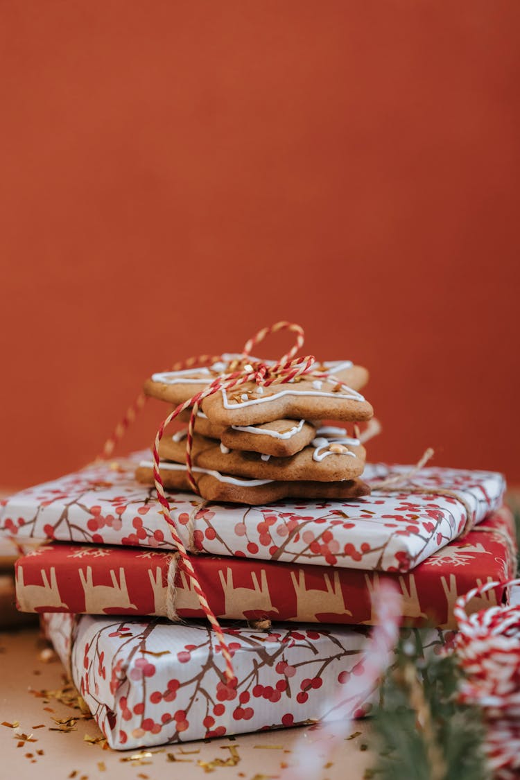 Vertical Studio Shot Of Star Shape Ginger Breads And Pile Of Wrapped Presents