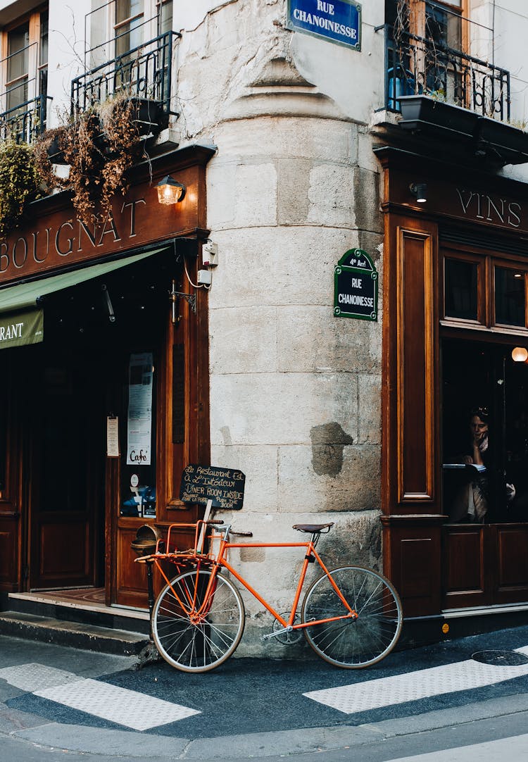 A Red Bike Parked On Street Corner