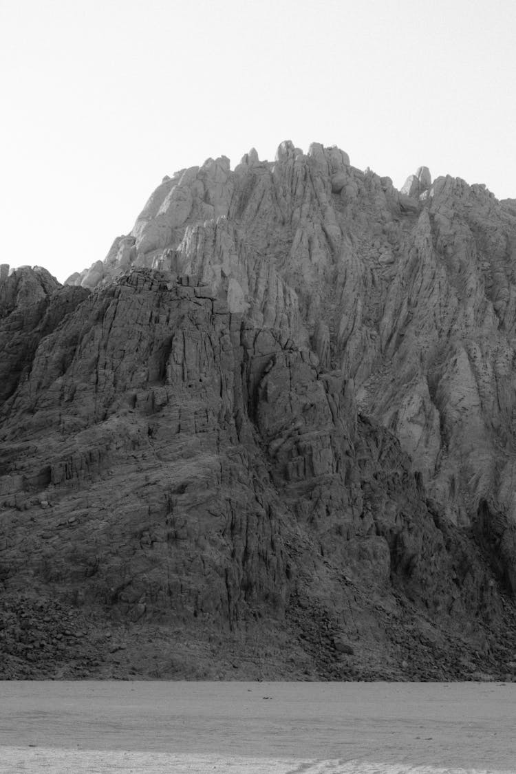 Grayscale Photo Of A Desert Mountain