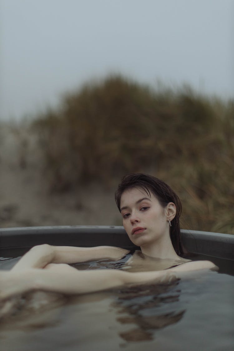 Woman Dipping In An Outdoor Hot Tub