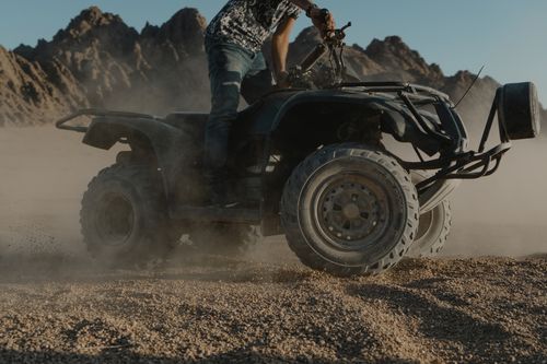 Free A thrilling ride on an all terrain vehicle through desert landscape, capturing the essence of adventure. Stock Photo