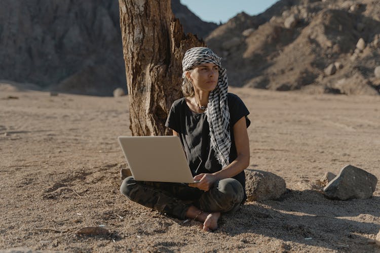 Woman In Black Shirt Sitting On The Ground