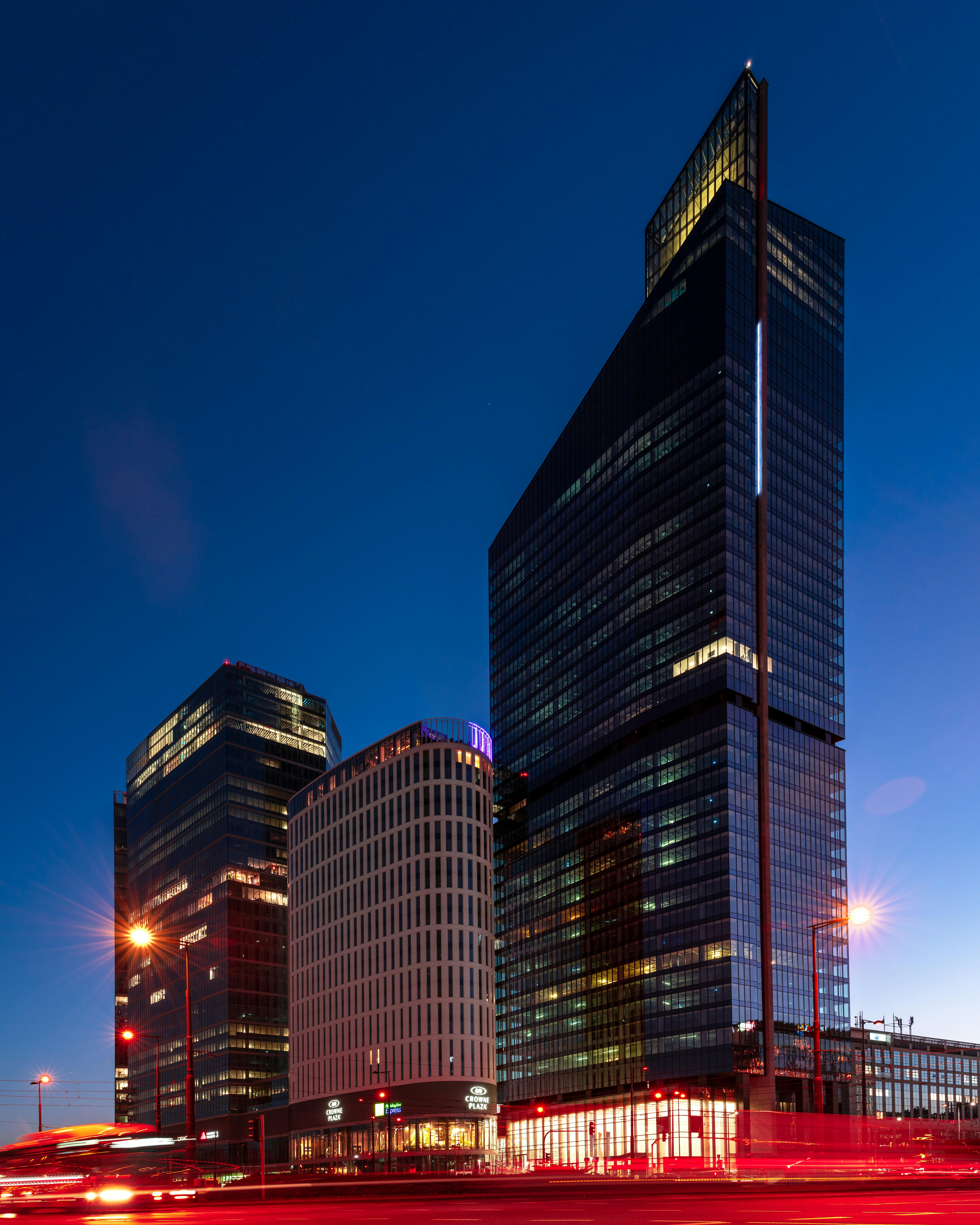 A stunning nighttime view of modern glass skyscrapers in Warsaw, Poland.