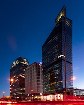 A stunning nighttime view of modern glass skyscrapers in Warsaw, Poland.