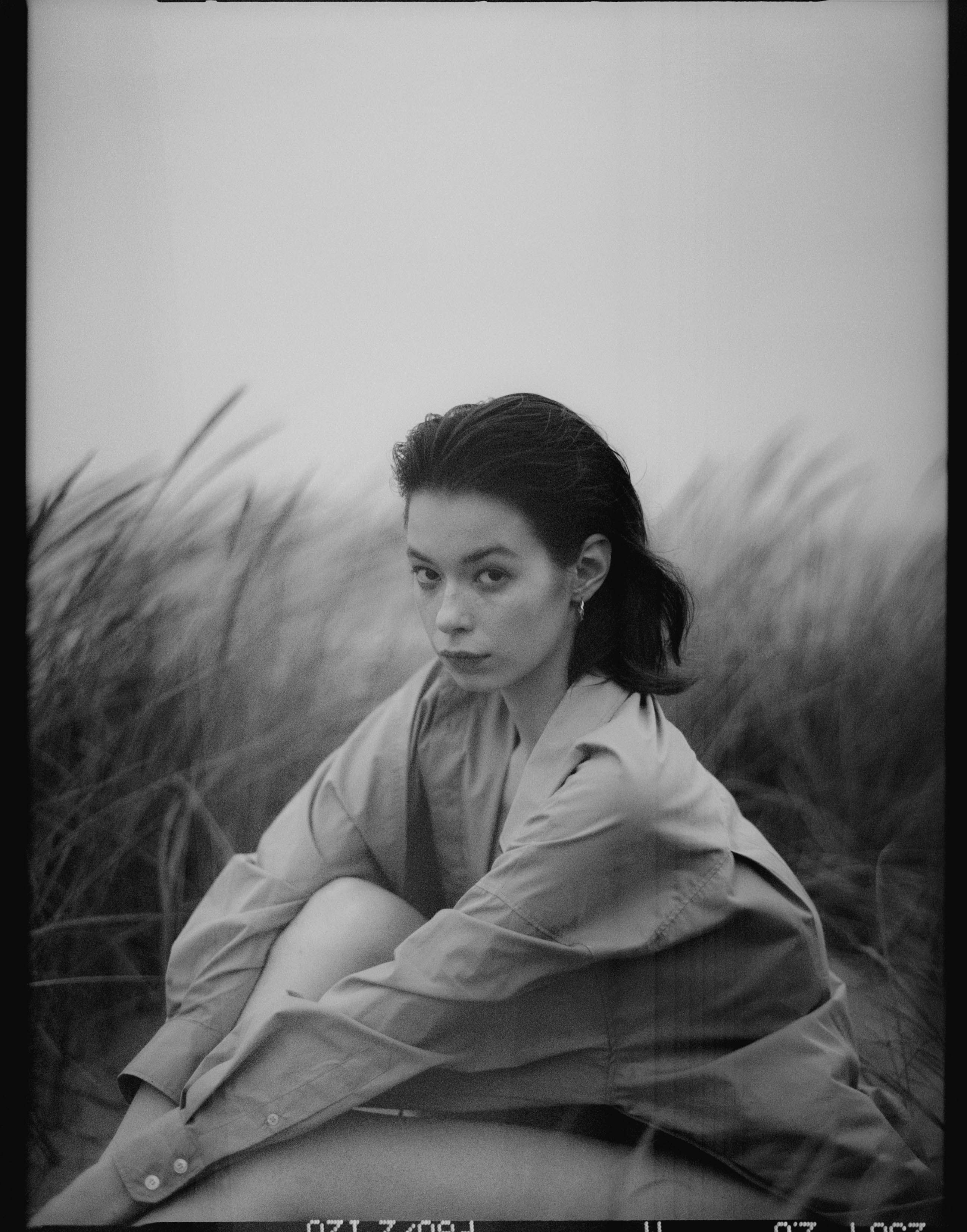 Grayscale Photo of Woman Sitting on the Grass · Free Stock Photo