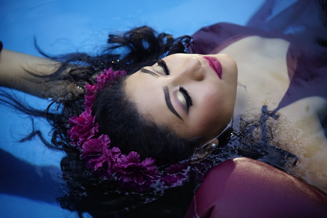 Woman with Flower Headdress Floating in the Water 