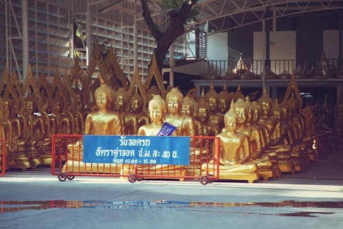 Free Many golden Buddha statues kept in spacious storehouse Stock Photo