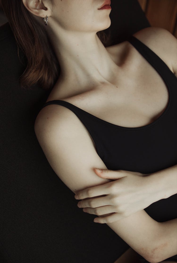 
A Close-Up Shot Of A Woman Touching Her Arm