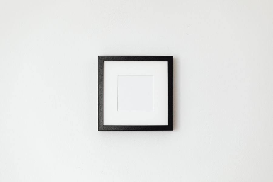 A black frame with a white mat