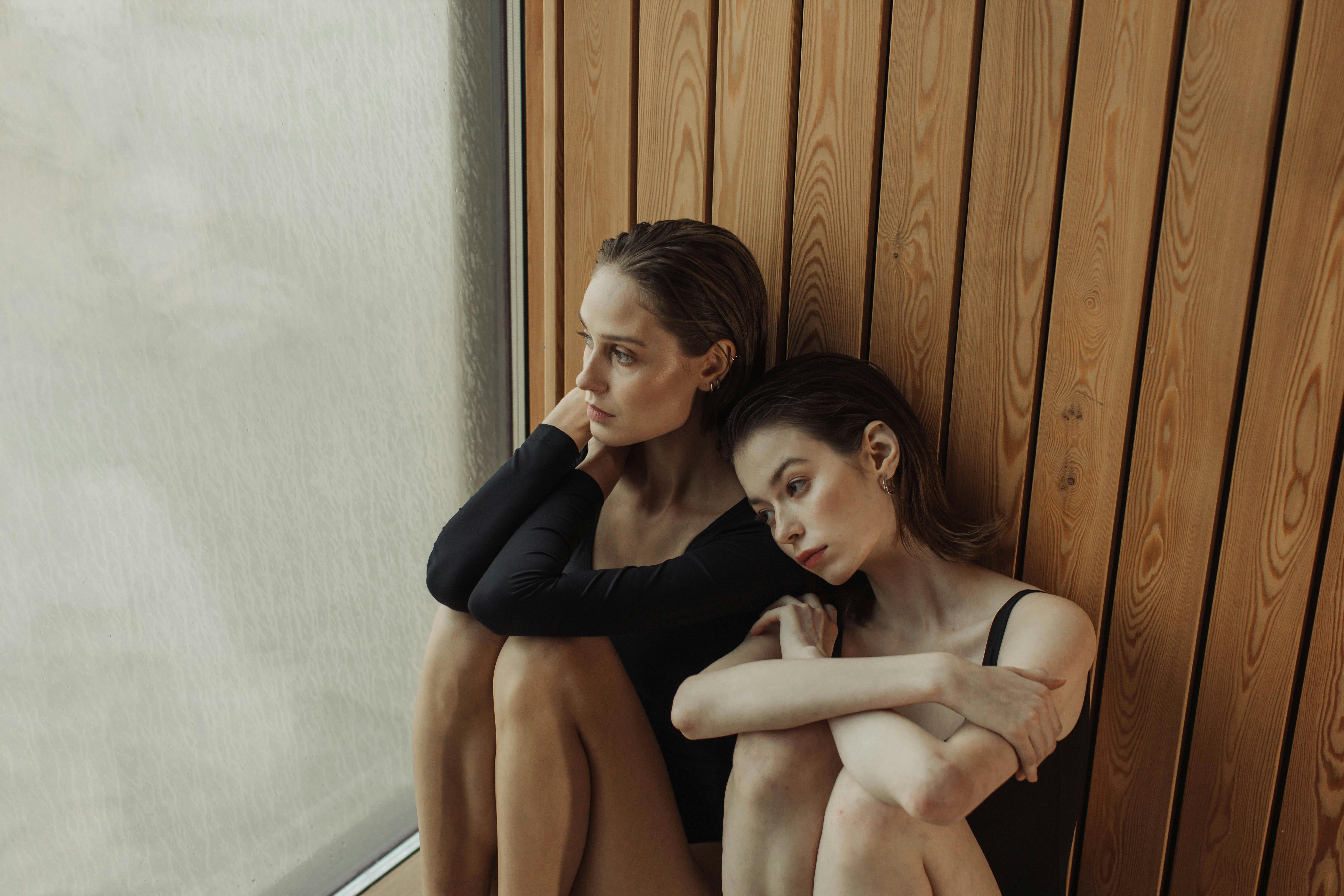 Two women sitting together in a serene spa room, exuding relaxation and peacefulness.