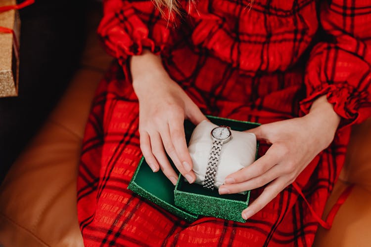 Person Holding A Green Box With Silver Wrist Watch Inside 