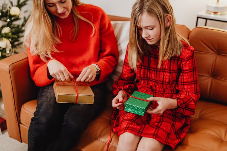 Blonde Woman And A Girl Opening Christmas Presents 