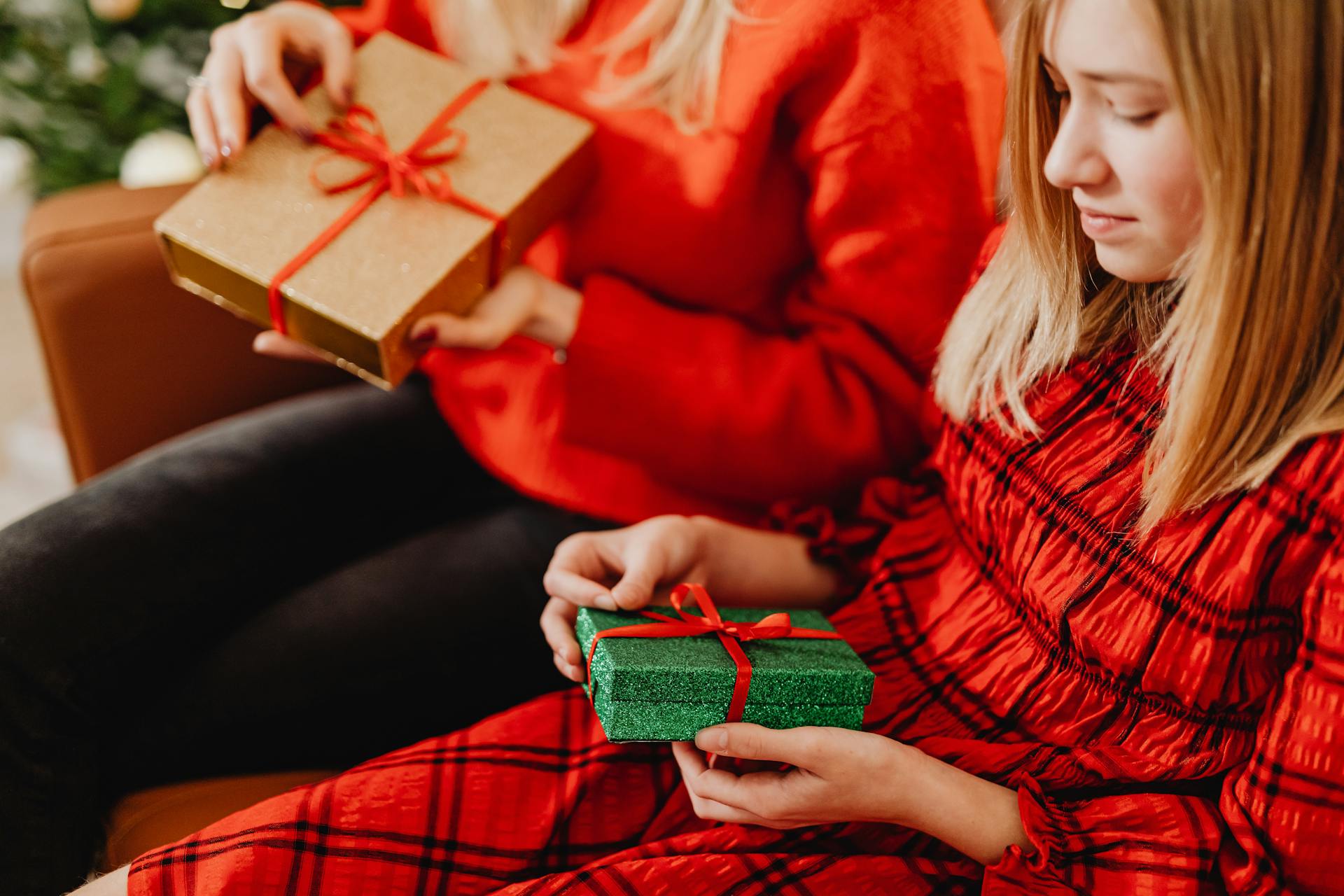 Two people exchanging gifts in a cozy, festive setting, perfect for holiday themes.