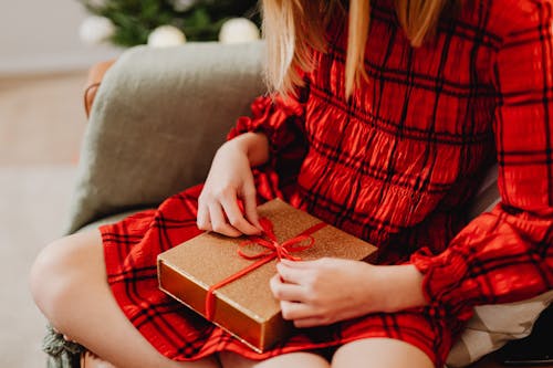 Woman Opening a Christmas Present 