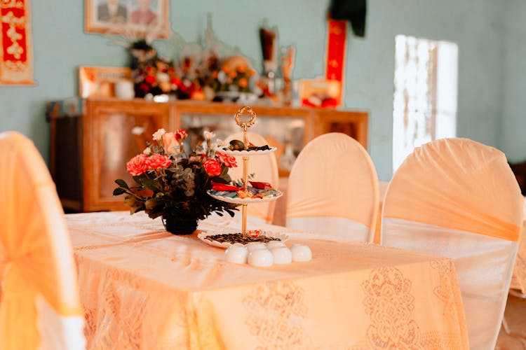 Pastel Colour Table Cloth And A Bouquet On Table In An Old Fashioned Cafe