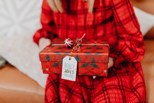 Close Up Shot of a Person Holding a Christmas Gift