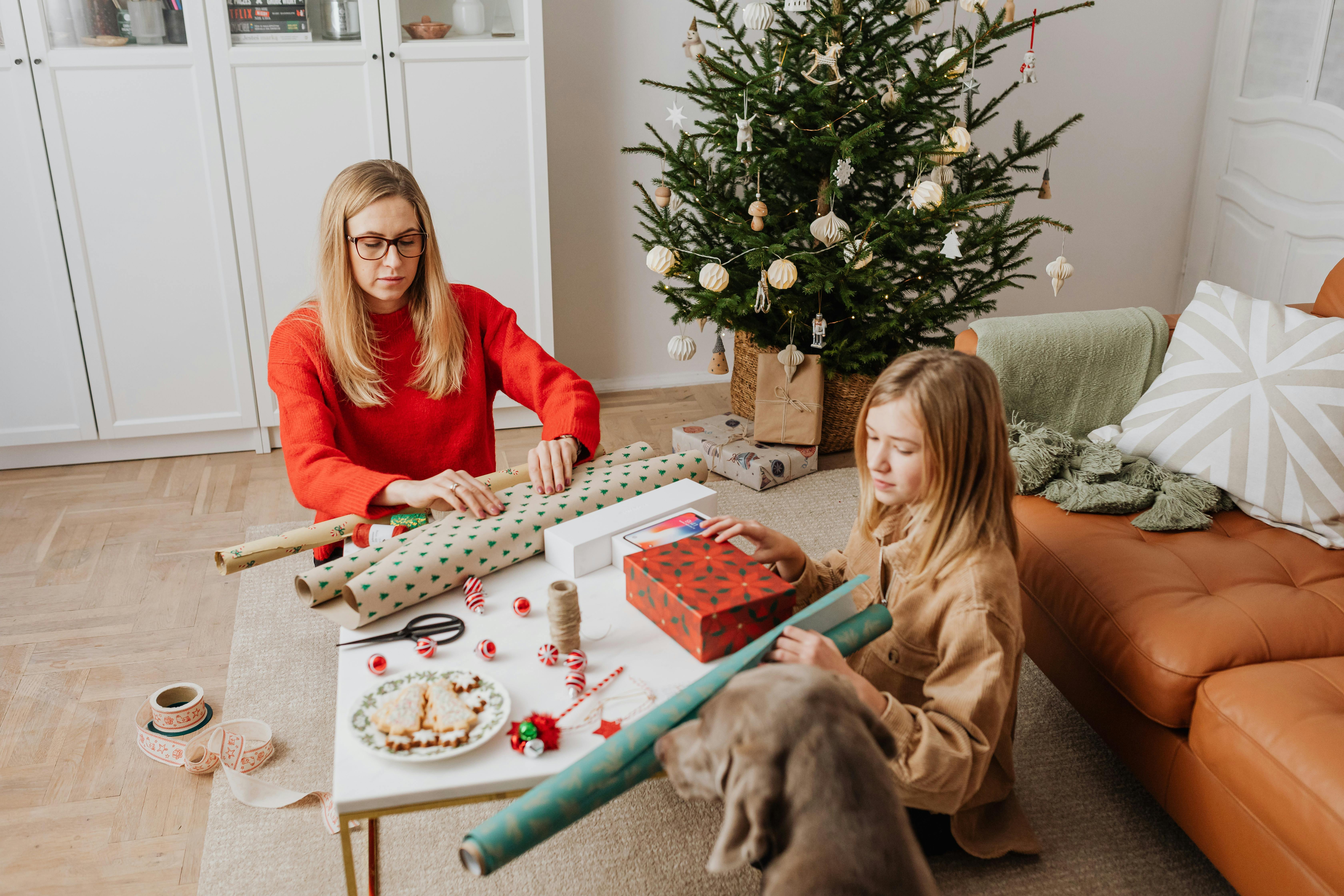 mother and daughter wrapping a gift