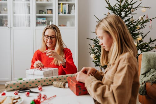 Free Woman and a Girl Wrapping Gifts Stock Photo