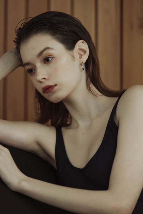Free Elegant portrait of a woman indoors showcasing thoughtful expression and minimalistic style. Stock Photo