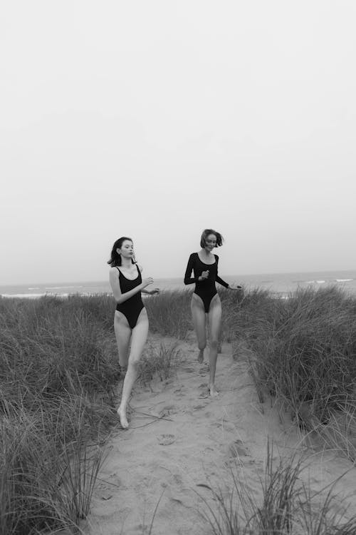 Monochrome Photo of Two Women wearing Black Bodysuit