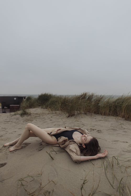 Sexy Woman Lying on Brown Sand
