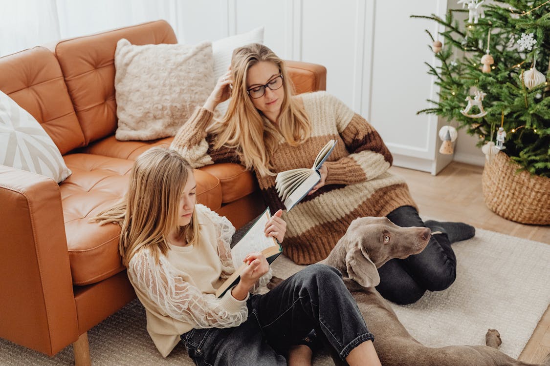 Free Mother and Daughter Sitting on the Floor Reading Books  Stock Photo