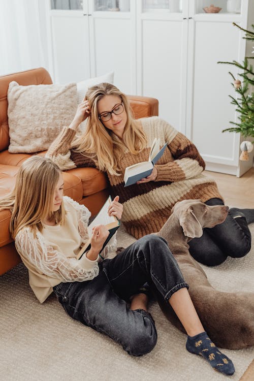 Free Mother and Daughter Reading Books with their Dog  Stock Photo