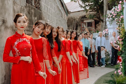 Free A Group of Women in Red Long Sleeve Dress Standing  Stock Photo