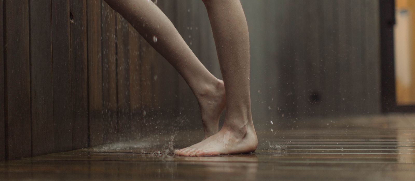 Standing on a soaked wooden floor indoors