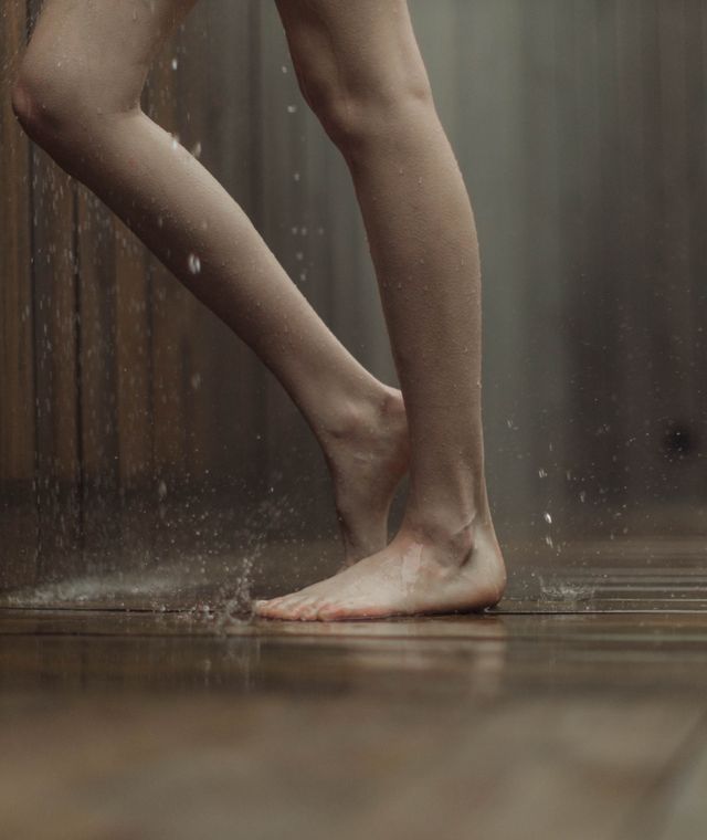 Standing on a soaked wooden floor indoors