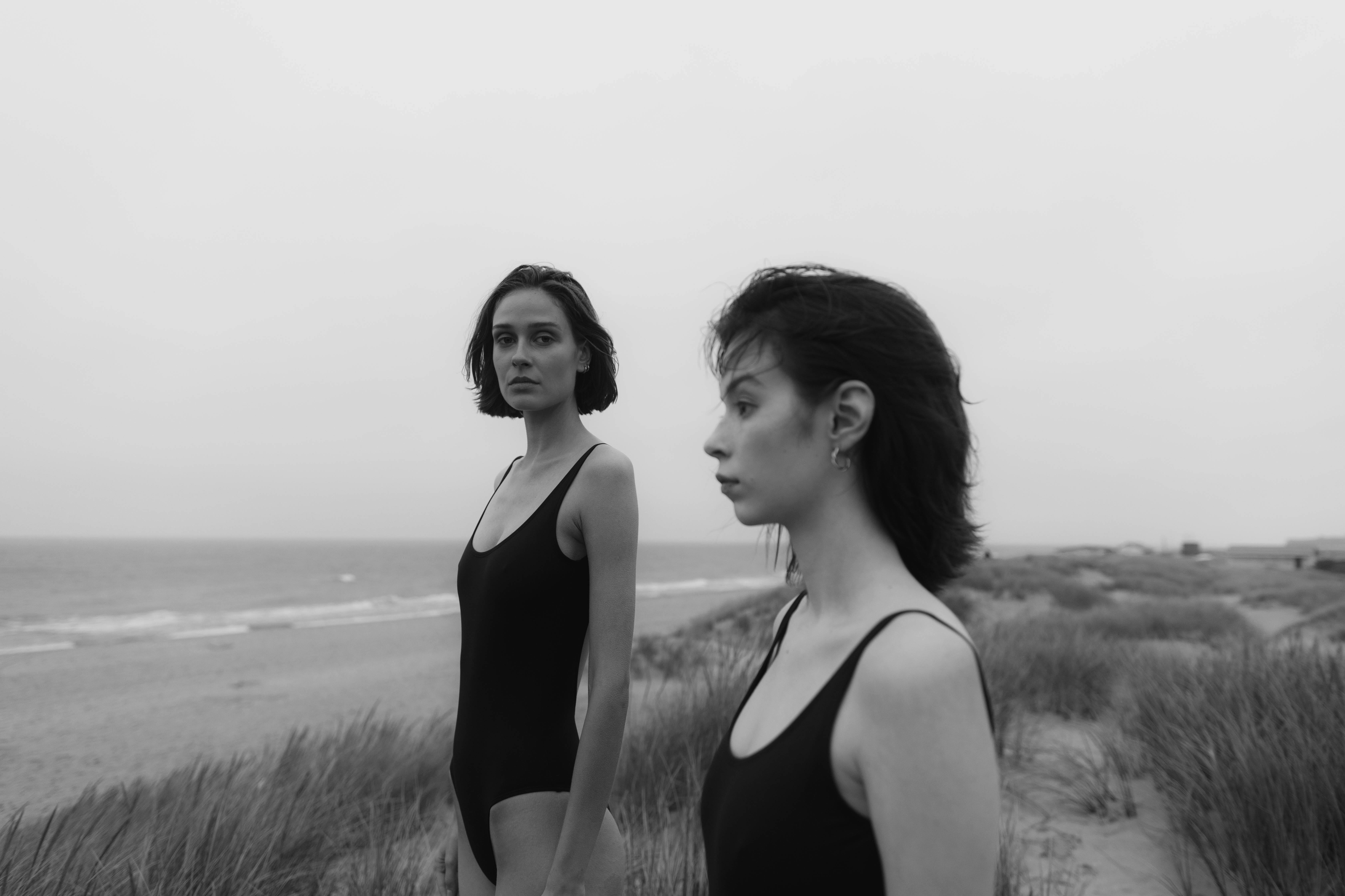 woman in black tank top standing on seashore