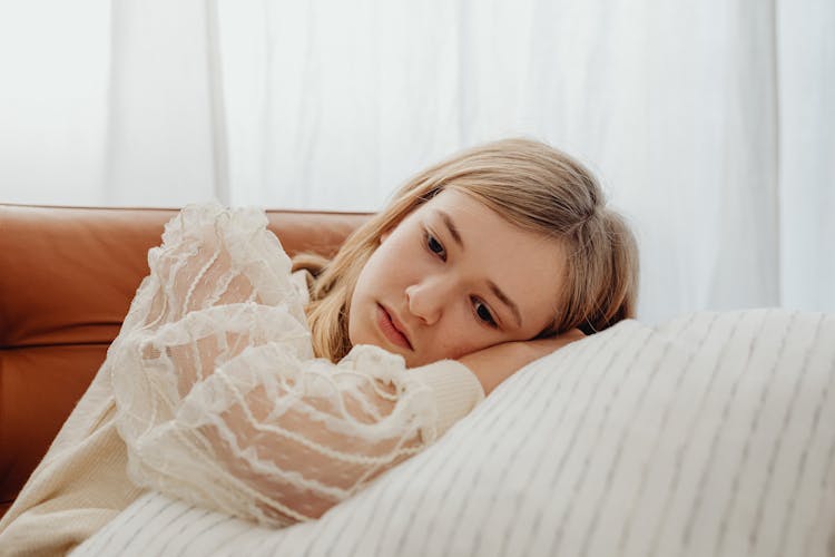 Sad Teenager Lying On Pillow