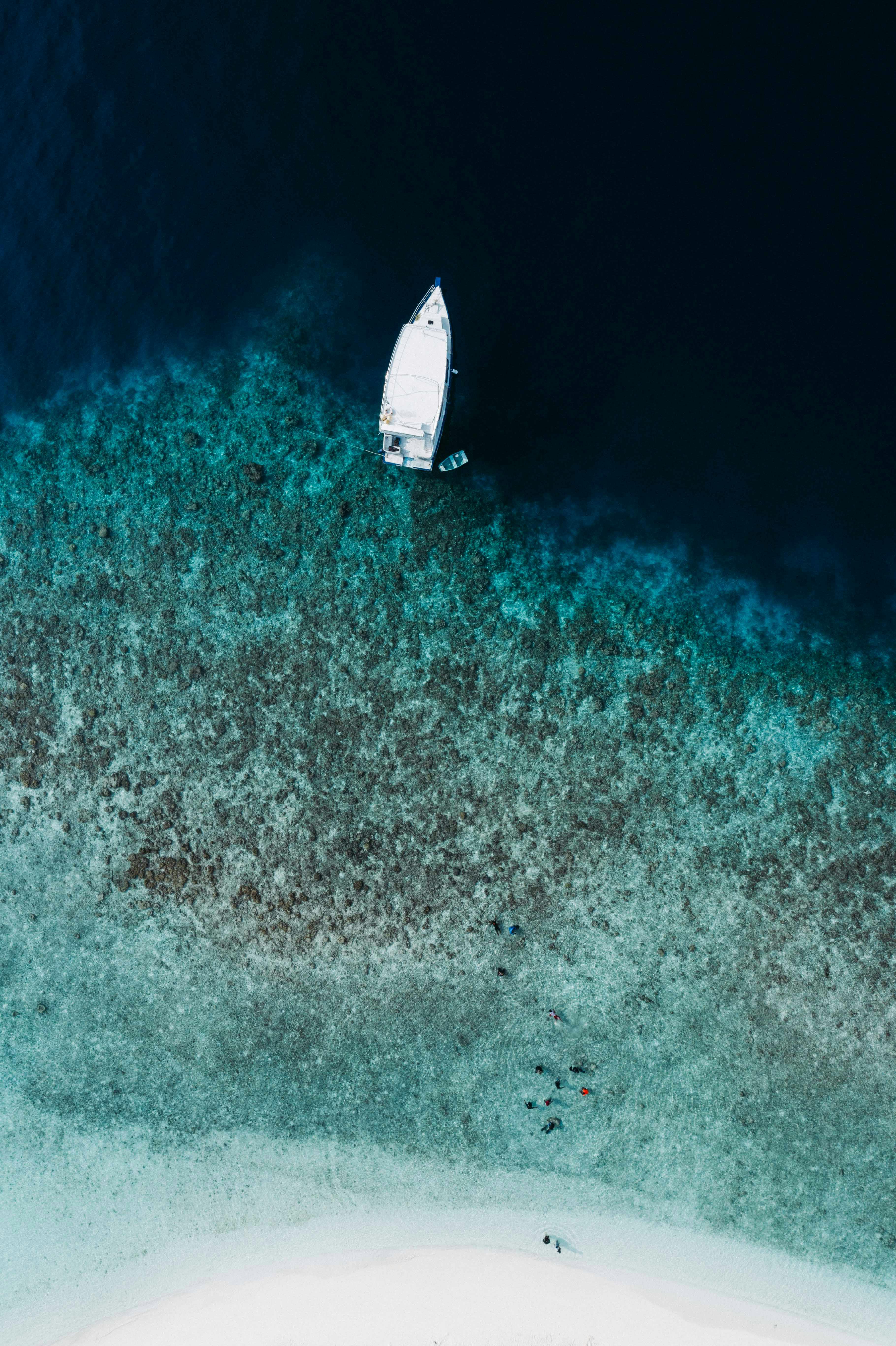 aerial modern motorboat moored on shallow sea coast