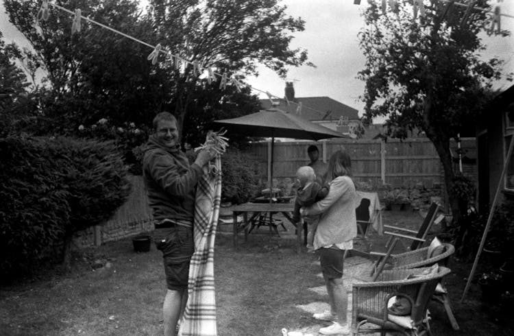 People Enjoying Their Time In A Garden On The Backyard 