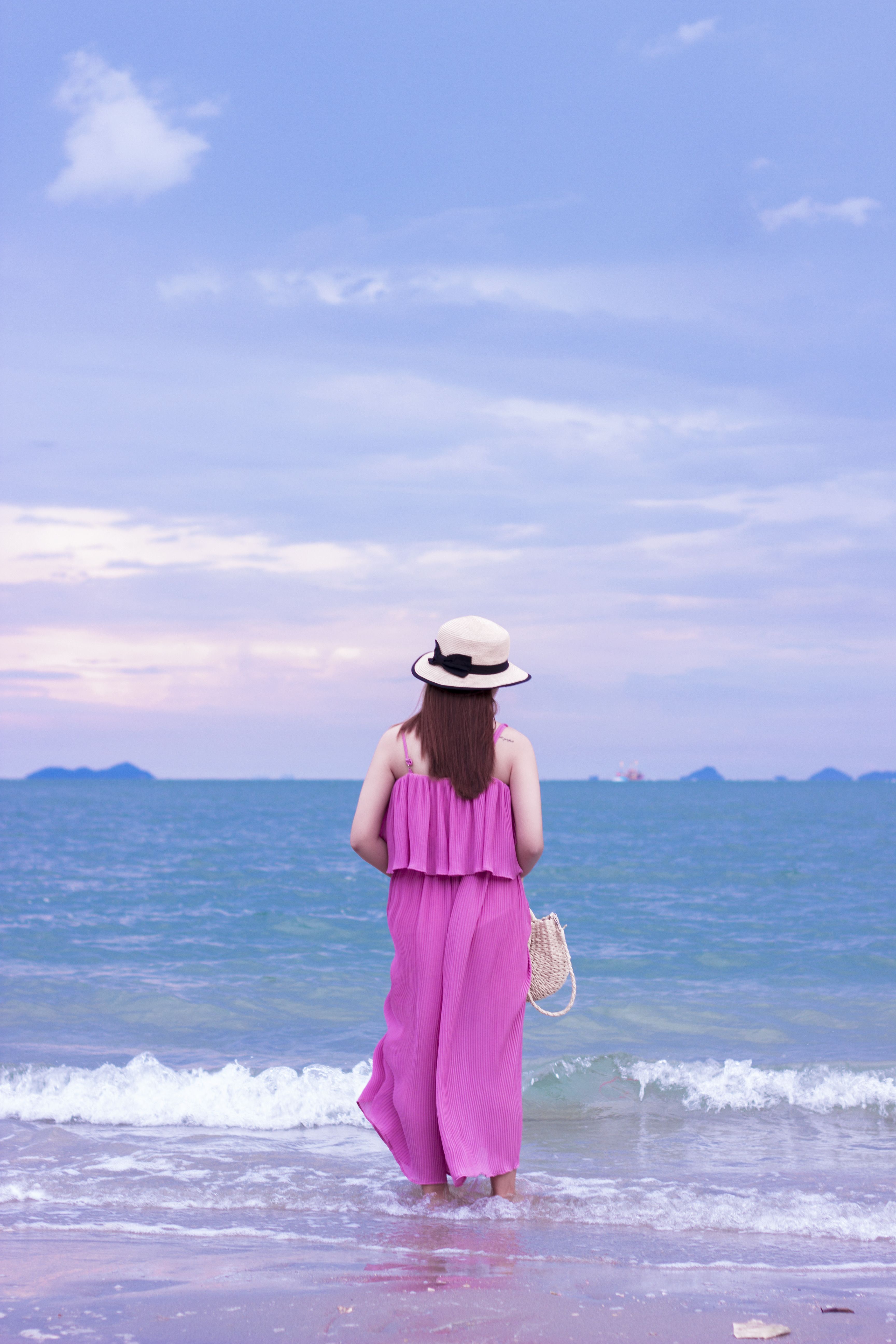 Woman in a Pink Dress Wading in a Sea · Free Stock Photo